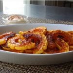 Roasted delicata squash in a white dish on a table