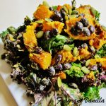 Roasted pumpkin and black bean salad on a white plate