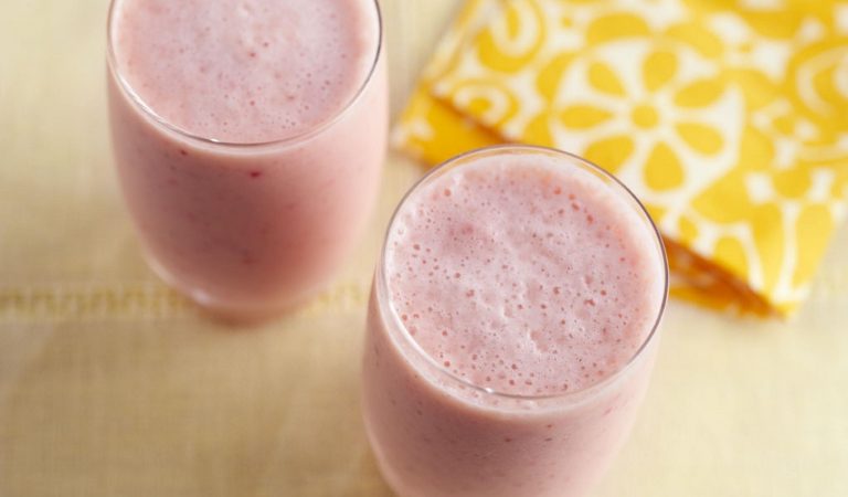 Two very berry smoothies with yellow napkin on a table