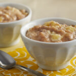 Banana pudding in a bag placed in two bowls with spoon