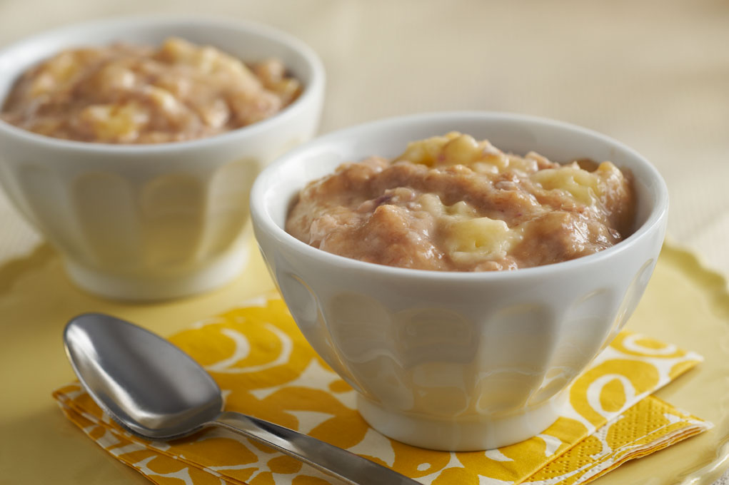 Banana pudding in a bag placed in two bowls with spoon