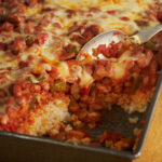 Bean and rice botana in a baking dish on a wooden table