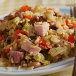 Black-eyed peas and rice in a white dish on a table