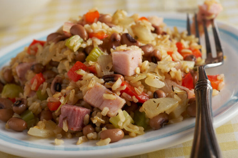 Black-eyed peas and rice in a white dish on a table