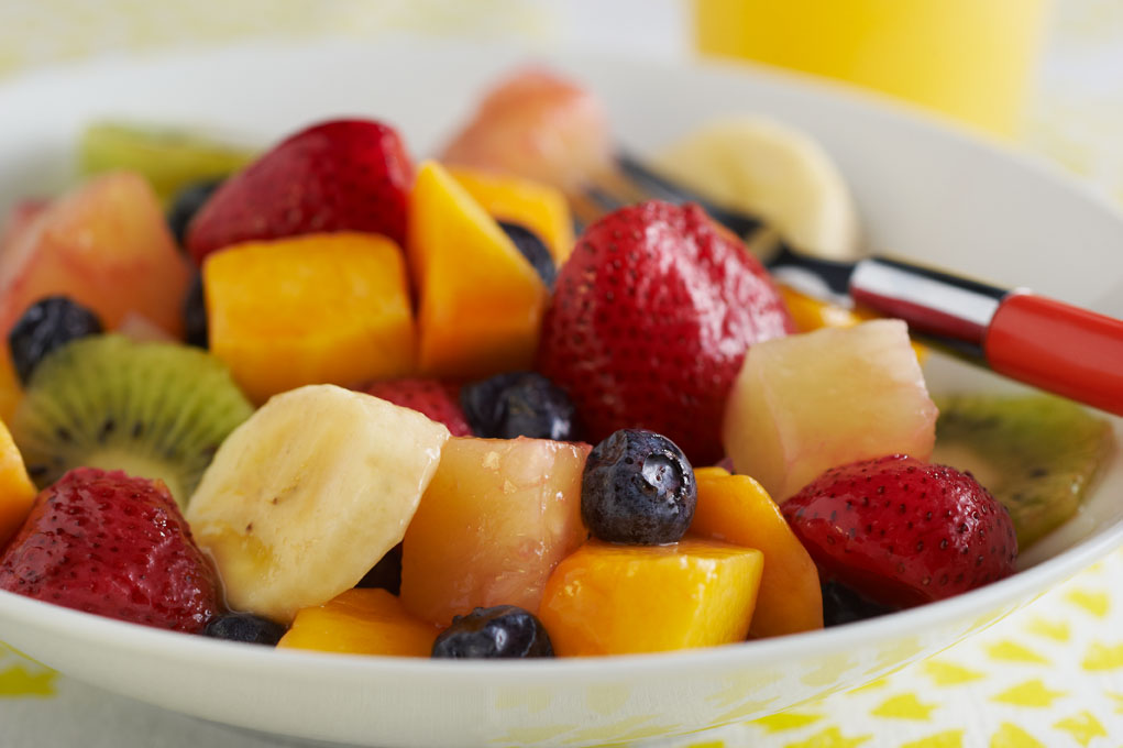 Fruit salad in white bowl on table