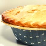 Burrito Pot Pie in a blue pie tin on a white serving dish.