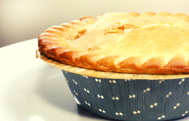 Burrito Pot Pie in a blue pie tin on a white serving dish.