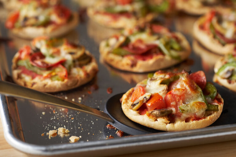 Mini pizzas on a baking sheet.