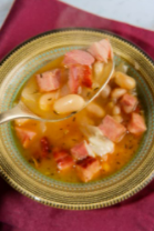 Navy bean soup in a green bowl.