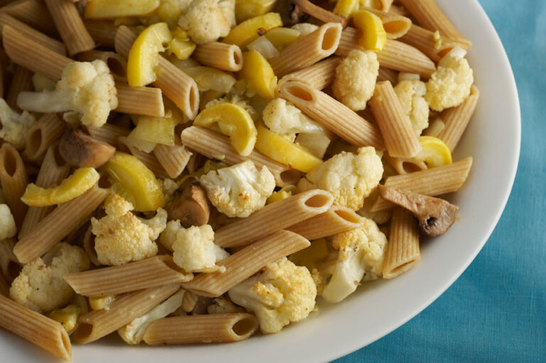 One bowl of pasta with roasted squash and cauliflower.