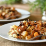 Two white plates with roasted rutabaga.