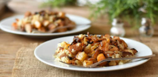 Two white plates with roasted rutabaga.