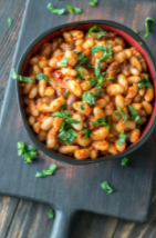 Dark colored bowl of pinto bean salsa.