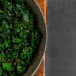 Dark green sauteed kale in a bowl.