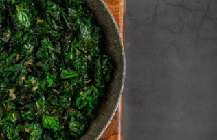 Dark green sauteed kale in a bowl.