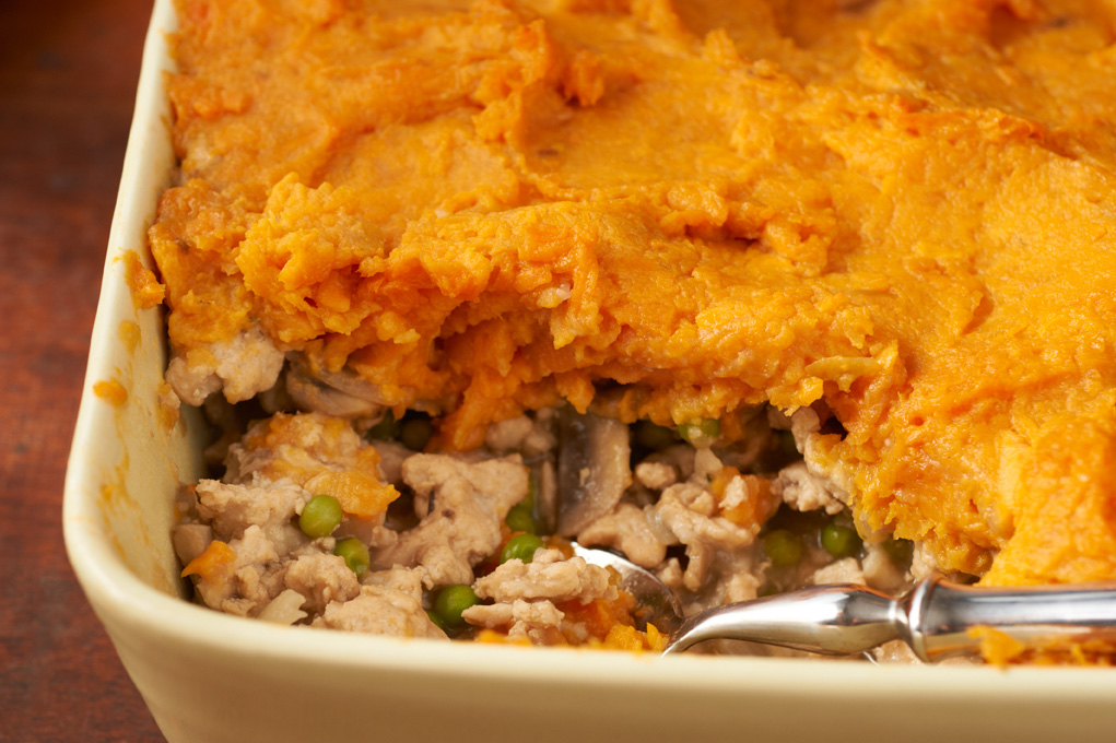 Closeup of sweet potato shepherds pie in a white baking dish