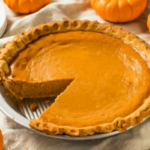 Pumpkin pie surrounded with decorative pumpkins.