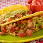 A closeup of turkey tacos on a green plate