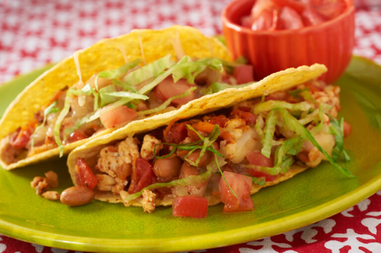 A closeup of turkey tacos on a green plate