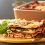 Vegetable lasagna on a yellow plate