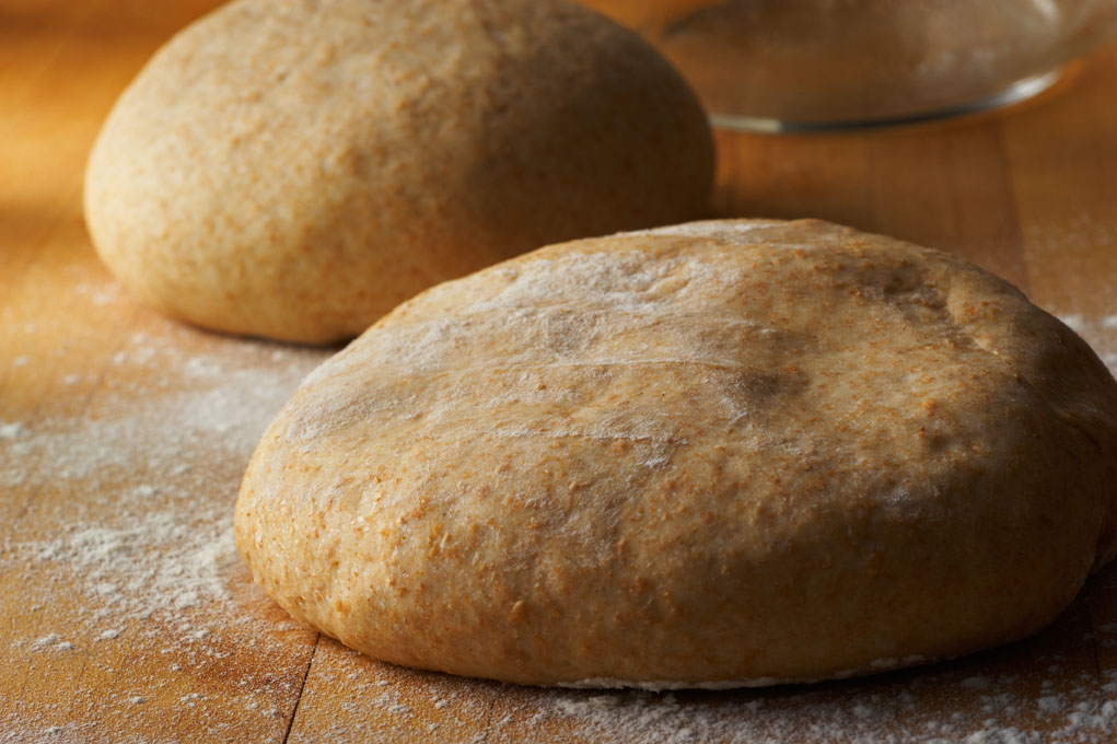 Two balls of whole wheat pizza dough