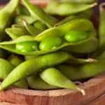 Edamame in its pod in a wooden bowl.