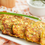 Zucchini patties on a long, rectangular white plate.