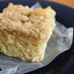 Square piece of coffee cake on top of a clear wrapper.