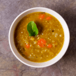 Bowl of Split Pea Soup with Roasted Carrot with a leaf