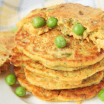 Stacks of pea pancakes with peas on top