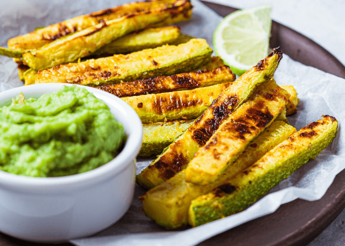 sliced zucchini fries with cup of guacamole