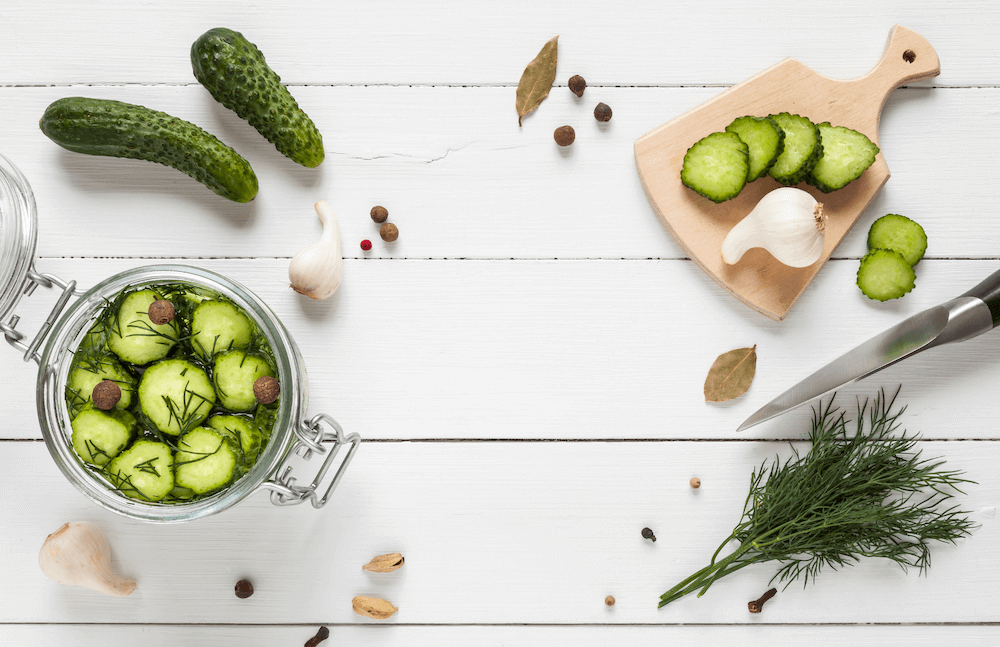 Pickles and cut up cucumbers on a table