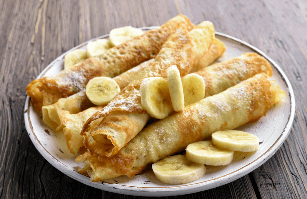 Whole wheat banana crepes with cut bananas on top