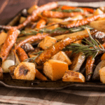 A baking sheet filled with different kinds of roasted root vegetables.
