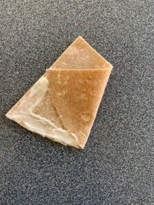 A triangle-shaped piece of dough with one corner folded on top