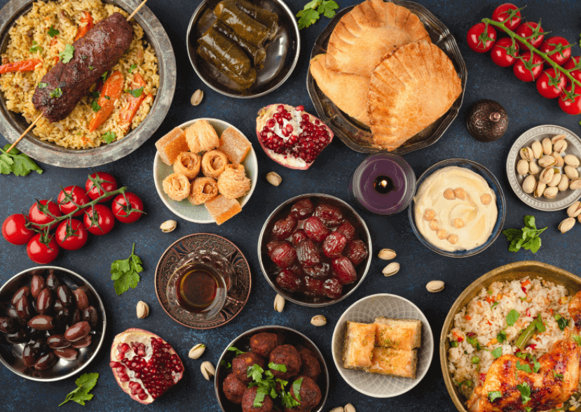 Several plates of various food spread out over a table