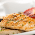 Baked perch fillet with bread crumbs, topped with parsley.