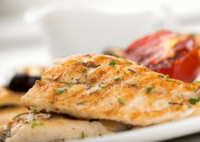 Baked perch fillet with bread crumbs, topped with parsley.