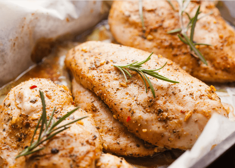 Three lightly seasoned chicken breasts.