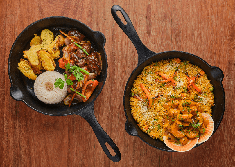 Two skillets with Hispanic dishes.