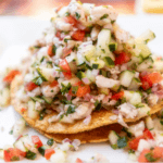 Chopped tomato, onion, pepper, scallions on top of hard shell tortillas.