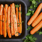 Chopped carrots in a dish with whole carrots on the side.