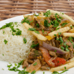 White rice, French fries, tomatoes, onions, sirloin trips, topped with fresh herbs.