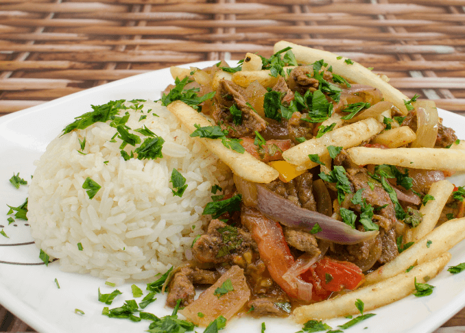 White rice, French fries, tomatoes, onions, sirloin trips, topped with fresh herbs.