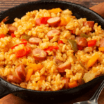 Jambalaya rice, veggies, and sausage in a cast iron pan