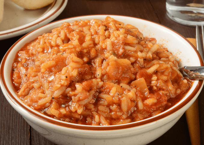 Vegetables and jambalaya rice in a white medium bowl.