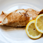 Apple slices in a tortilla with cinnamon on a white plate with two lemons.