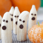 Half bananas with chocolate chips to resemble ghosts.