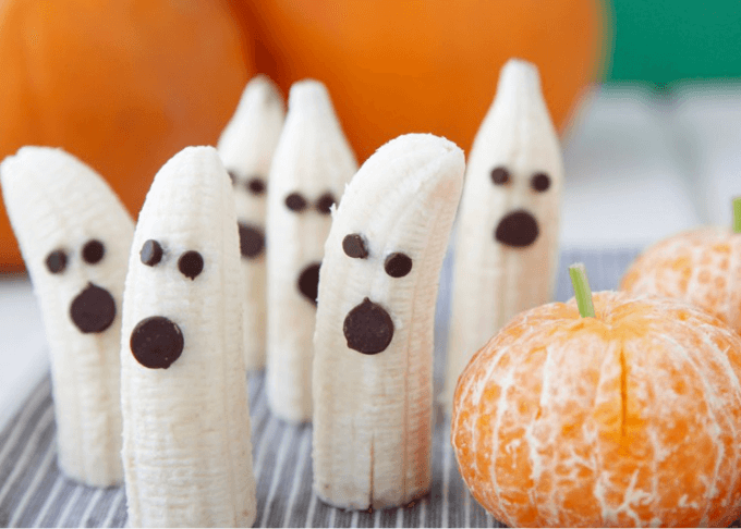 Half bananas with chocolate chips to resemble ghosts.