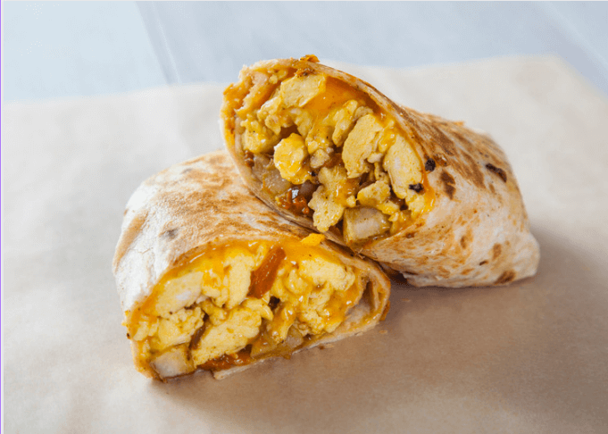 Two halves of egg and cheese breakfast burritos.